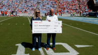 Two people holding an oversized check