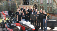 Group of students in front of race car