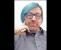 A person in glasses and a streak of light blue hair in a virtual meeting. "I had issues at other jobs."