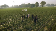 People stood near a sign in a field