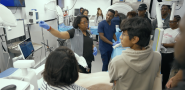 Instructor speaking to students and displaying medical equipment