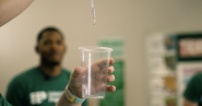 Person holding a cup of water