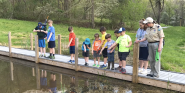 children on bridge over water