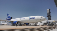 A large plane with Orbis logo on the side.