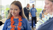 Smiling child wearing Make-A-Wish t-shirt