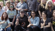 A group photo of people holding plastic forks