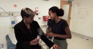 A person sat in a medical room getting their blood pressure taken