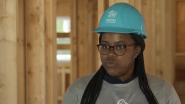 Ryan Estmond wearing a safety hat inside of a building under construction  