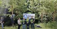 people holding plants in front of trees