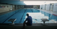 person in front of swimming pool