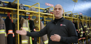 First responder in front of firefighting equipment