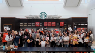 group of people standing in front of a Starbucks