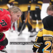 Two women facing off in a hockey match.