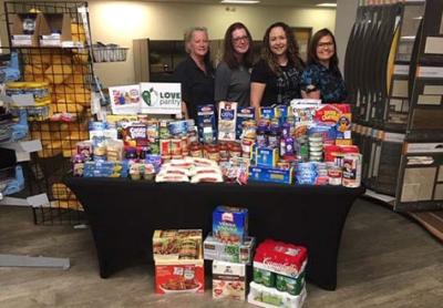 Gathering food for schoolchildren in need during the summer months at Dal-Tile Sales Service Center in Orlando, Florida.