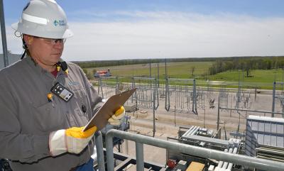 Max Benson Jr. checks equipment daily in the combined-cycle plant, adjacent to the switchyard. The syngas produced in the gasifier fuels two combustion turbine generators to produce electricity. Steam produced from heat in the gasification process, and from heat in the exhaust gases from the combustion turbines, is recovered to drive a third turbine, making additional electricity.
