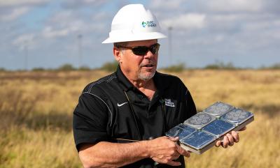 Tim Hayes holds the Bat Deterrent System, designed by NRG Systems. It's a set of six speakers that emits a high frequency from the top of a wind turbine to discourage bats from approaching.