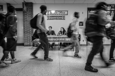 Students walk past a voter registration table at Hoover High School on National Voter Registration Day on Sept. 25, 2018. Phil Roeder / Flickr