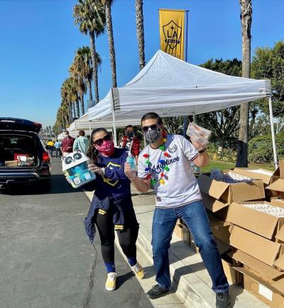 AEG employees and LA Galaxy supporter groups distribute the toys at Dignity Health Sports Park drive-thru toy giveaway event