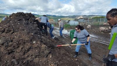 Grand Grand Teton Lodge Company staff volunteer at a local farm who is composting the lodge's food waste. The farm then uses the organic waste as compost for the produce sold back to the lodges and community. In just three summers, nearly 500,000 pounds of food waste has been composted. PHOTO CREDIT: Grand Teton Lodge Company