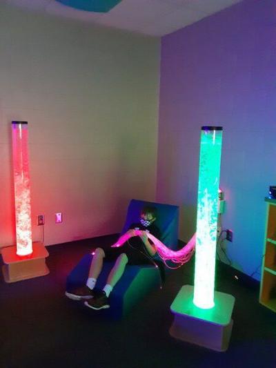 Chase Vowels, 12, enjoys a chair that pulsates to music inside the new sensory room at New Hope Middle School. (Ryan Anderson/Daily Citizen-News)