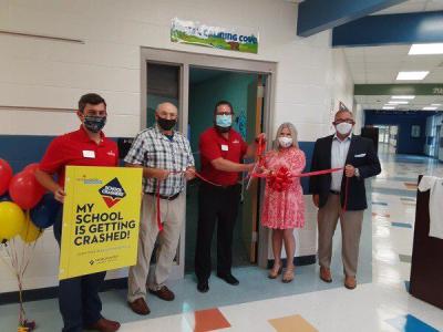 Aaron Chestnut, chief marketing officer for Georgia United Credit Union, and Belinda Sloan, principal of New Hope Middle School, cut the ribbon for the school's new sensory room while flanked by representatives from Georgia United and Mohawk Industries and Varnell Mayor Tom Dickson. (Ryan Anderson/Daily Citizen-News)