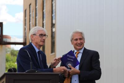 Wisconsin Governor Tony Evers, left, presents Beloit College President Scott Bierman with a state energy efficiency award during a ceremony on Wednesday commemorating the Beloit College Powerhouse redevelopment project.