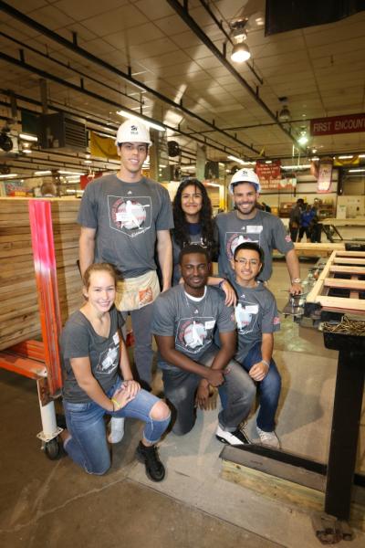 Major Leaguers Christian Yelich (in hard hat on left) and Jose Altuve (in hard hat on right) are flanked by Sam Houston High School students who volunteered in support of the Players' efforts to build house frames for Houston flood victims