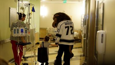 AEG’s LA Kings mascot Bailey walks the halls of Children’s Hospital Los Angeles with a patient during the team’s annual visit to CHLA on January 16, 2018.