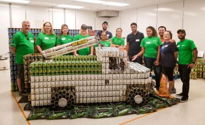 SCE volunteers show off their version of an electric bucket truck after a practice build before the Canstruction event.