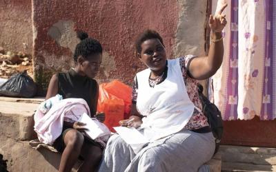 L to R: A mother and her infant with Annette, a community health worker. Photo credit: David Givens for Global Citizen