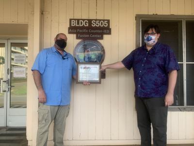 Derek Furman: Booz Allen Associate Derek Furman was recently recognized by the U.S. Army’s Pacific Counter-IED Fusion Center (AFCFC) for his efforts related to a significant IED event in the Philippines, presenting him with the APCFC Strong Rower Award.