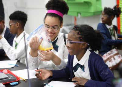 A chemical reaction generates a big reaction from Detroit Enterprise Academy seventh-graders Schyla Ward (left) and Amore Nelson. The students are among 4,500 students in Detroit, Dundee, Sterling Heights and Warren, Michigan who are benefitting from a new STEM education program made possible by a grant from the FCA Foundation to the Cranbrook Institute of Science.