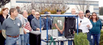 WHIRLPOOL CLEVELAND Plant Manager Dicky Walters, with microphone at the right, coordinated a noon program and cookout Thursday, to pay tribute to the plant's 51 veterans. The Bradley County Funeral Honor Guard also attended. Photo Credit: Larry C. Bowers