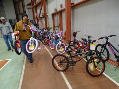 Eddie Hatfield, who started the bike donation program with his colleagues at Whirlpool Corp. three years ago, carries 2 of the 36 bicycles that will be given away Wednesday through the Toys for Tots program. (Photo: Craig Shoup/The News-Messenger)