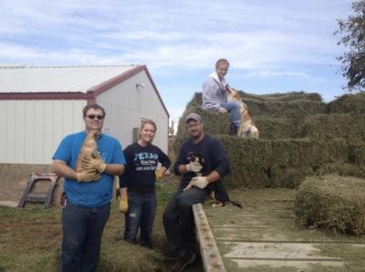 Koryne Carlson, with her dad, brother and sister, unloading a rack of hay. “My sister would throw the hay off the hay rack onto the ground and my dad, brother and I would carry it to the shed where we stacked for the winter.”