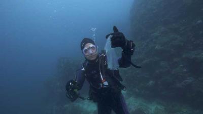Fisk Johnson, Chairman and CEO of SC Johnson, holds up a piece of plastic pollution he found in the water.