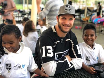 LA Kings forward Kyle Clifford (center) and students from St. Anthony explore G.O.A.L.S., a digital platform that helps equip children in Los Angeles with resources to be eco-friendly, inclusive, healthy, socially responsible and knowledgeable, on a tablet on November 8, 2017.