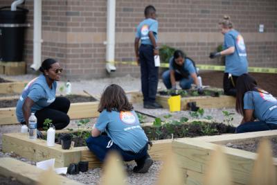 Volunteers worked with students to plant the expanded edible garden at the Seatack Elementary School in Viriginia Beach at a Timberland-convened service event held prior to the Something in the Water festival.
