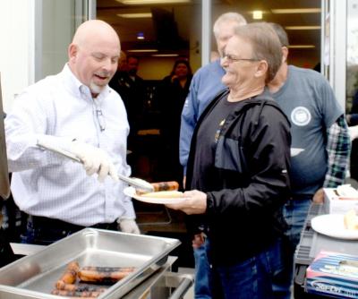 WHIRLPOOL CLEVELAND employee and veteran Gordon Heughan, right center, shares a laugh with Plant Manager Dicky Walters on Thursday. The Cleveland facility treated its 51 veterans to a luncheon cookout and a 21-gun salute by the Bradley County Funeral Honor Guard. Photo Credit: Larry C. Bowers