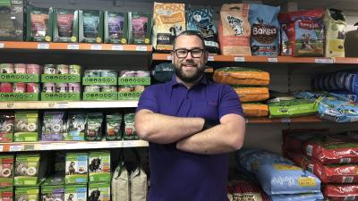 Mike in the dog food aisle of the HugglePets store, prior to the COVID-19 pandemic.