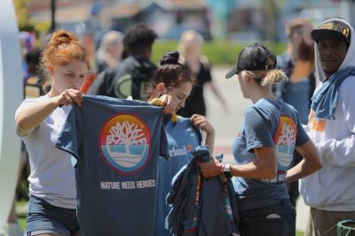 Something in the Water festival attendees check out the Timberland t-shirts they earned after making a pledge to live a little greener.