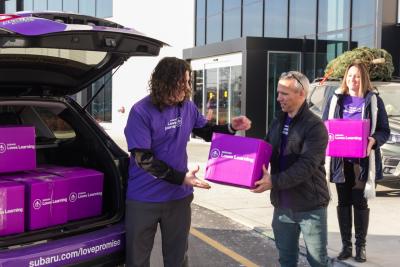 Subaru of America employees load boxes of donated books for local Camden schools as part of ‘Subaru Loves Learning’ initiative.