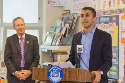 Camden City School District Superintendent Paymon Rouhanifard addresses students, alongside Subaru of America President Tom Doll following the automaker’s donation of more than 3,000 science books to Camden schools. PHOTO CREDIT | Mark Nesbitt courtesy of iNTVNETWORK, LLC © 2017