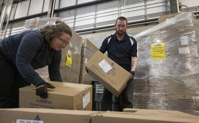 Ashly Yates (left) and Ryan Canney pack boxes of 20,000 Intel-donated surgical masks on Wednesday, March 25, in Hillsboro, Oregon. The shipment was bound for health care professionals in Santa Fe, New Mexico. The shipment is part of Intel’s donation of 1 million units of personal protective equipment to help prevent the spread of contagion to workers who are helping treat coronavirus patients. (Walden Kirsch/Intel Corporation)
