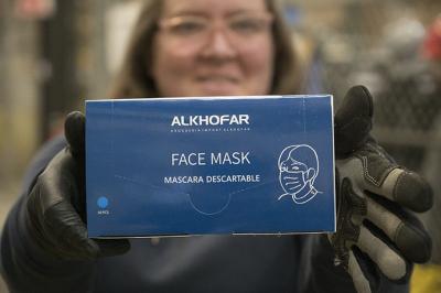 Ashly Yates displays a box of Intel-donated surgical masks on Wednesday, March 25, in Hillsboro, Oregon. The box was among a shipment of 20,000 masks bound for health care professionals in Santa Fe, New Mexico. The shipment is part of Intel’s donation of 1 million units of personal protective equipment to help prevent the spread of contagion to workers who are helping treat coronavirus patients. (Walden Kirsch/Intel Corporation)