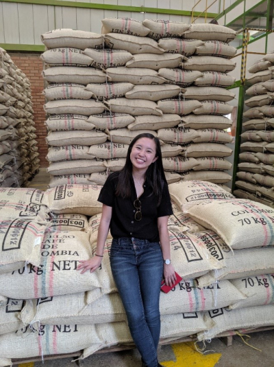 Albertsons Companies Own Brands Food Technologist Jenna Huynh with stacks of the company’s exclusive Signature RESERVE Antioquia Finca Orizaba beans in Jardín, Colombia.