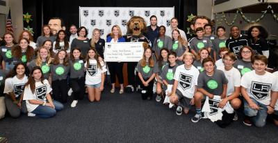 AEG’s LA Kings present Sandy Hook Promise Founder Nicole Hockley with a check for $360,000 following the partnership announcement to train youth and adults in violence prevention programs in Los Angeles-area schools and communities at Hermosa Valley School in Hermosa Beach, Calif. on September 24, 2019.
