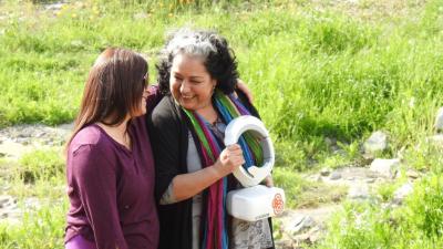 Marcela Rojas (right), a community leader in Las Perdices, Chile, learns about the implications of the DroneLab project, which is mapping high-risk areas to inform communities around disaster preparedness.