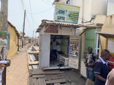 MARTIN IS WORKING WITH ID GHANA TO BE ABLE TO IMPROVE THE SITUATION OF HIS BATTERY BUSINESS, WHICH IS CURRENTLY SITTING PRECARIOUSLY OVER A CITY SEWAGE GUTTER, AS SEEN IN THIS PHOTO.