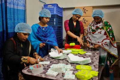 Women packaging Sokhipads in Bangladesh.